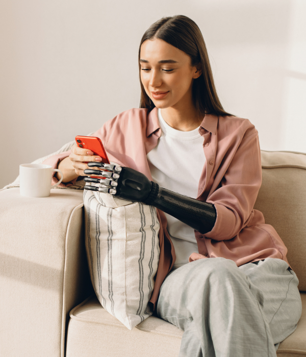 a young women using a mobile phone with a prosthetic arm