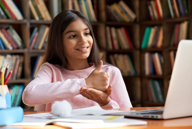 a young girl using sign language during a video call